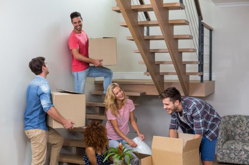 Moving team supporting a home removal in Eastsheen with boxes and furniture