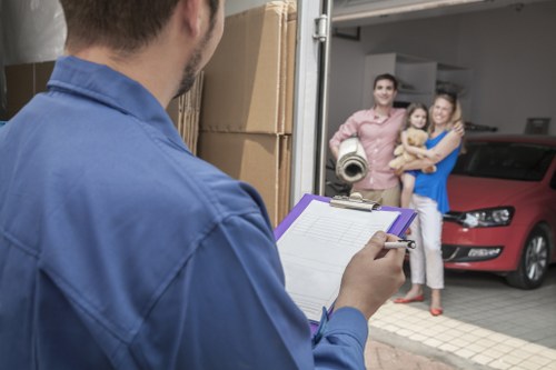 Professional movers carrying household items through a residential property