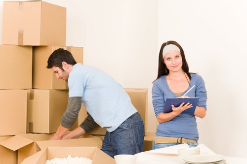 Careful wrapping of fragile household items during a packing service