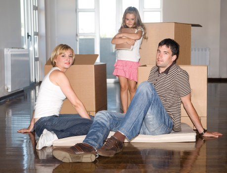 House movers carrying boxes through a South West London property